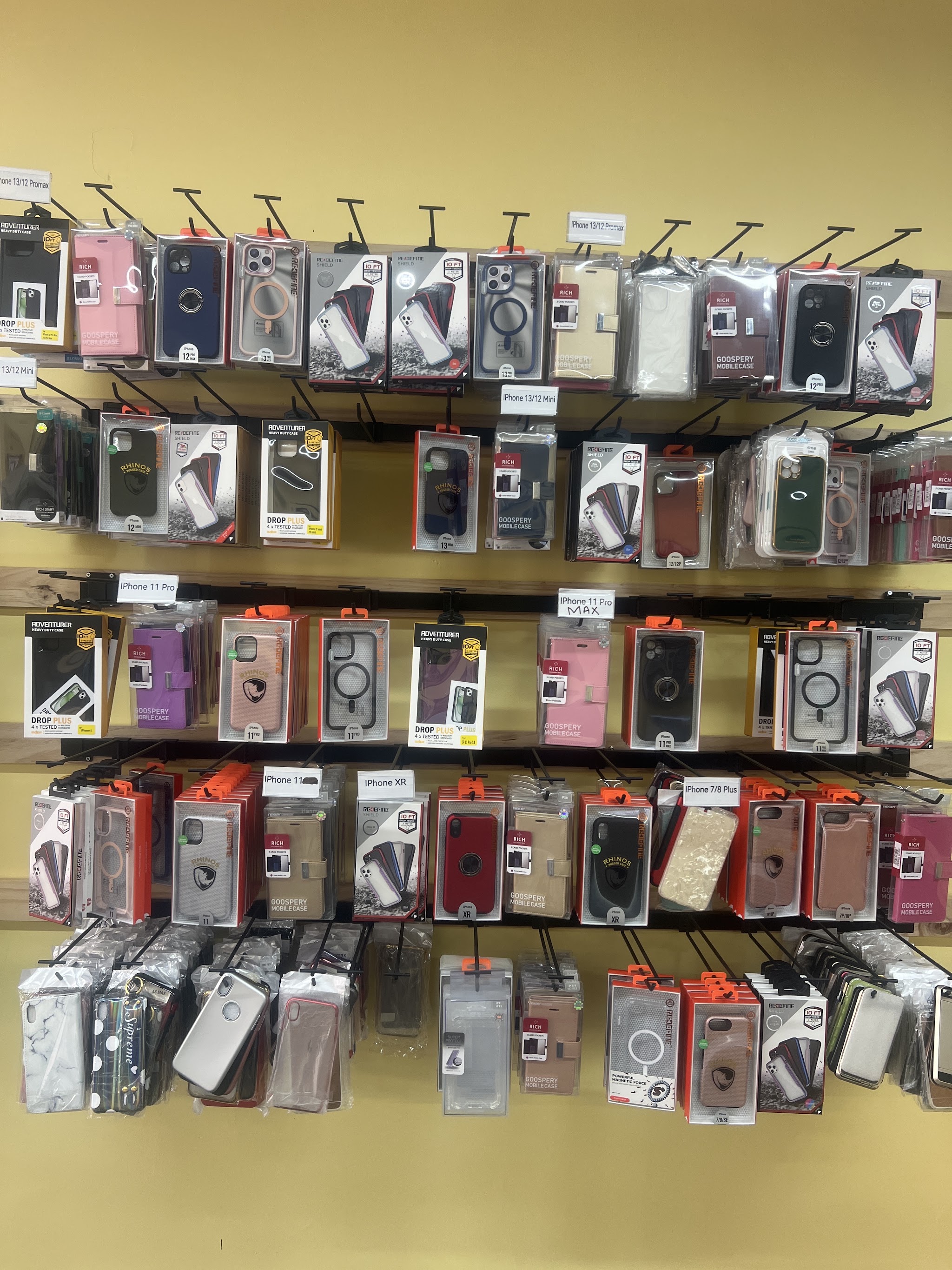 A wall of iPhone cases labelled by model